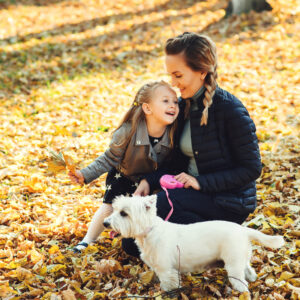 Mother daughter and dog in a field 