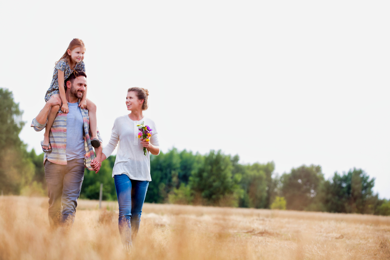 family walking in a field of crops