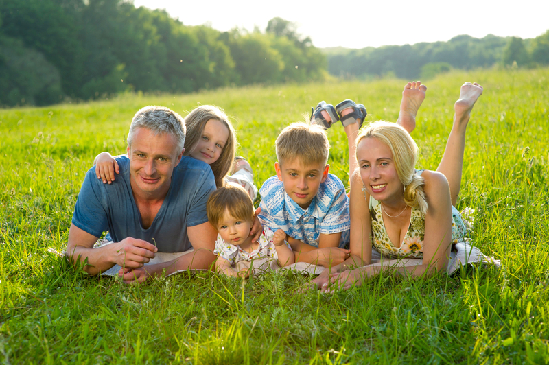 Family sitting in field