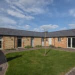 grass area and cottage